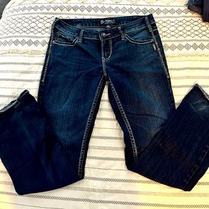 Silver jeans. Overall good condition- one hole near hem (see picture).